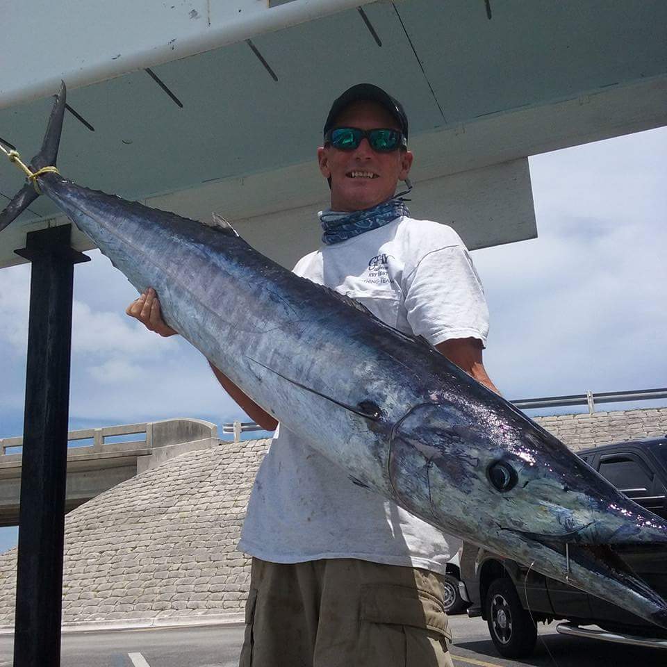 a man holding a fish