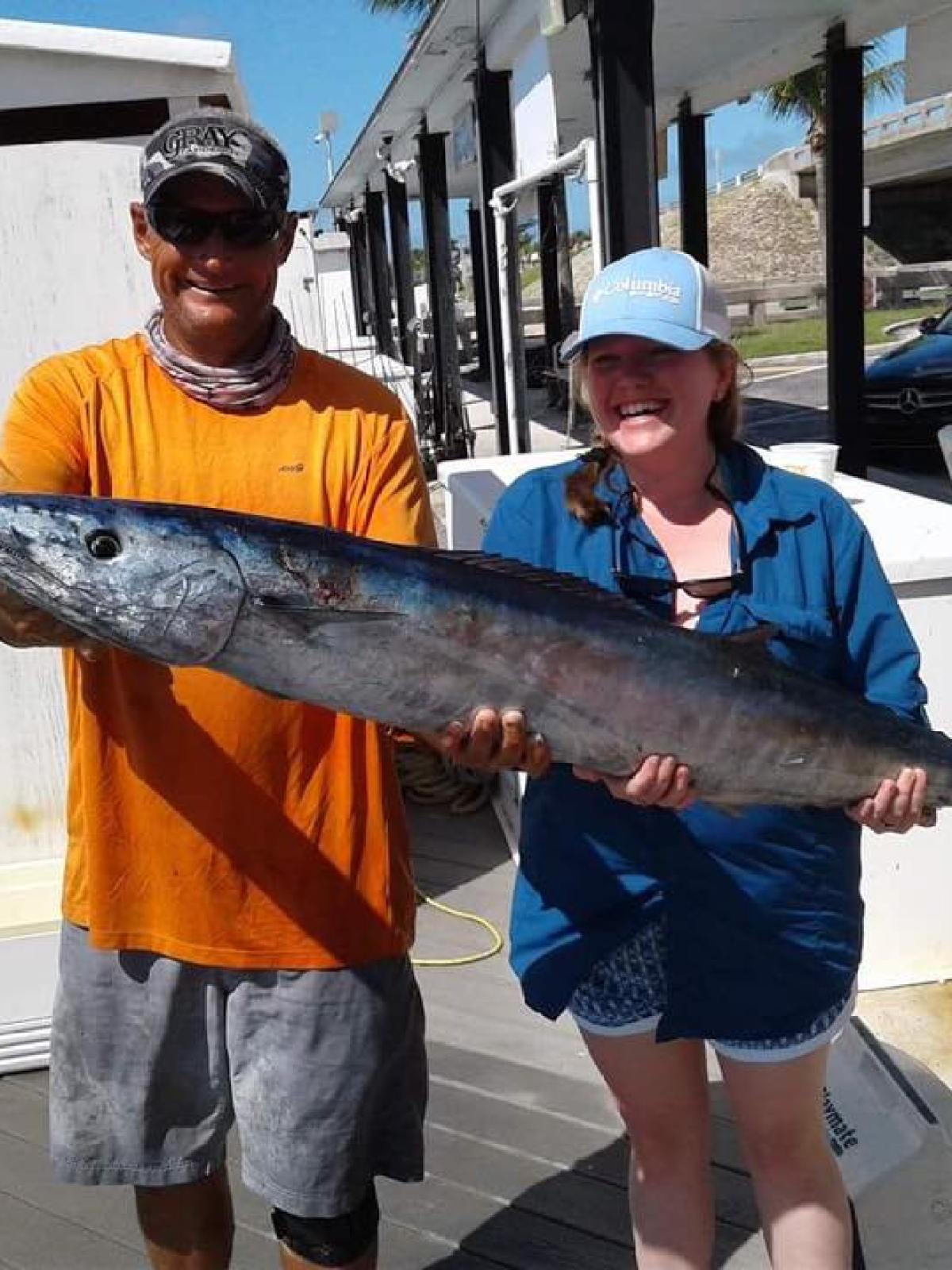 a man holding a fish