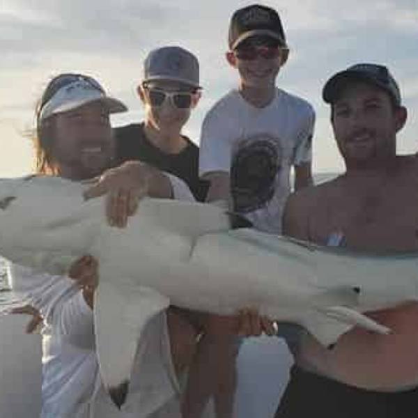 a person holding a fish in the water