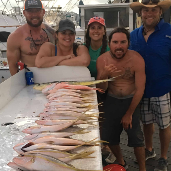a person holding a fish on a boat posing for the camera