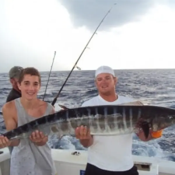 a man holding a fish in the water